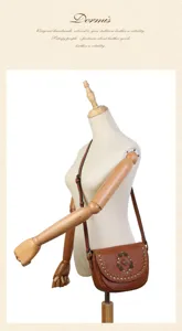 Vintage genuine leather saddle bag with handmade rivets and gemstone charms for women detail.