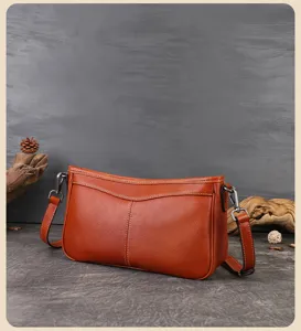 Detailed shot of retro brown leather shoulder bag, casual underarm baguette bag design.