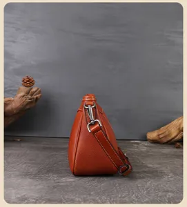 Detailed side view of vintage genuine leather shoulder bag, premium retro texture and hardware.