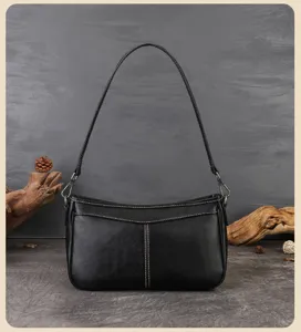 Black leather underarm bag detail, vintage stitch design and slim shoulder strap showcase.