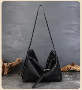 Detailed view of the black genuine leather hobo tote bag, featuring slouchy design and strap.