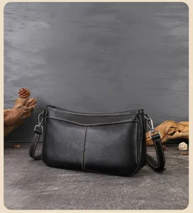 Vintage black genuine leather shoulder bag, chic underarm baguette handbag for women daily wear.