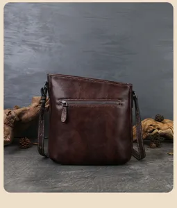 Retro genuine leather shoulder bag detail, dark brown cowhide with a front zipper pocket.