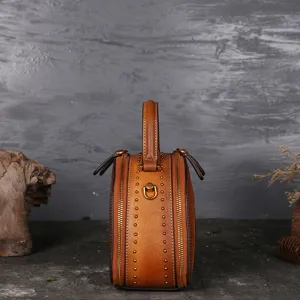 Vintage genuine leather round handbag for women, stylish retro crossbody shoulder bag.