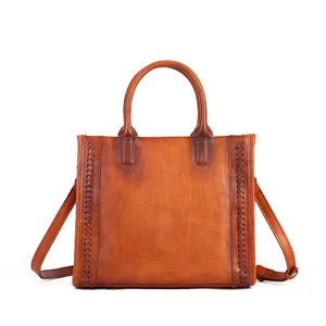 Vintage brown leather tote bag with woven side details, top handles and shoulder strap.