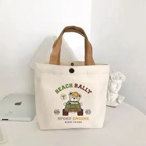 Compact canvas tote bag featuring cute cartoon bear print, versatile lunch bag for daily commuting.