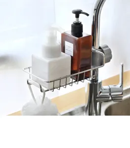 Detailed view of the stainless steel kitchen faucet storage rack holding soap dispensers in sink.