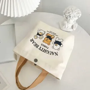 Canvas tote bag with cute cartoon bear print, minimalist handbag and bento bag for daily use.