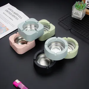Modern multi-color desktop ashtray with stainless steel inner liner, square and round shapes.