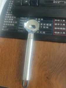 Stainless steel noodle slicer detail view, kitchen cooking tool with ergonomic handle and hanging loop.