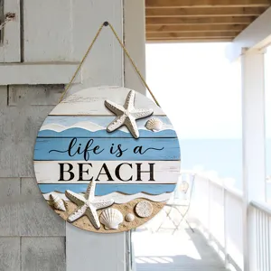 Coastal round wooden hanging sign with beach quote, starfish, and seashell decor for home.