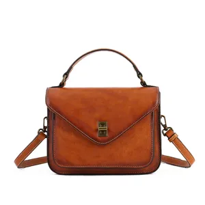 Vintage genuine leather messenger bag for women, stylish brown envelope handbag with top handle.