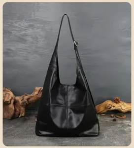 Detailed view of the black leather hobo shoulder bag showing soft texture and stitching.