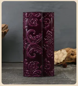 Detailed view of women's purple embossed leather long wallet with three-fold card slots.
