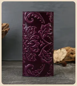 Exquisite genuine leather embossed long wallet for women with large capacity and multiple card slots.