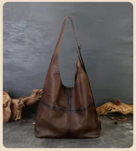 Vintage brown leather hobo shoulder bag detail, soft slouchy tote with wide adjustable strap.