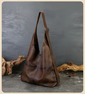Vintage genuine leather hobo shoulder bag detail, dark brown retro distressed cowhide tote.