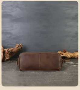 Detailed view of vintage genuine leather tote bag bottom with classic rustic background.
