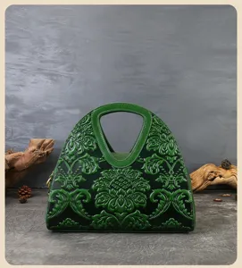Detailed view of the dark green embossed genuine leather vintage handbag with exquisite floral relief.