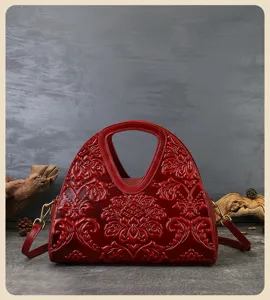 Retro ethnic embossed genuine leather handbag detail, elegant red shoulder crossbody bag.