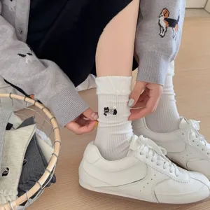 Detailed view of cute puppy embroidered women socks with pearl detail and bubble cuffs.