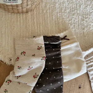 Close up of vintage floral and polka dot slouch socks detail, soft knit fabric style for women