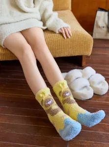 Soft coral fleece socks featuring cute cartoon bear design, cozy home wear detail.
