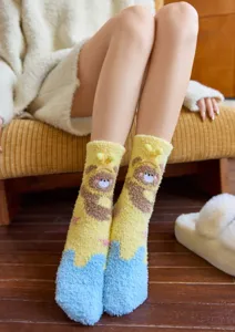Detailed view of women's thick coral fleece socks with cute cartoon bear design for cozy home warmth.