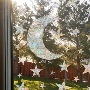 Detail van holografische zonneprisma raamsticker met kleurrijke regenboog lichtreflectie op glas.