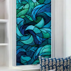 Close up view of geometric abstract blue and green stained glass window film in home decor.