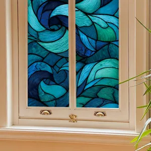 Abstract geometric stained glass window film detail showing vibrant blue wave design.