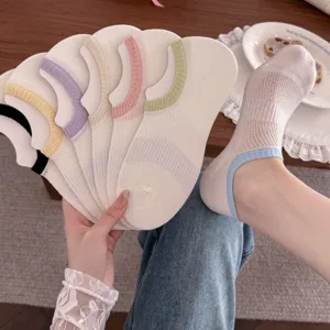 Detail shot of thin mesh women's low-cut boat socks with colorful trims in lifestyle scene.
