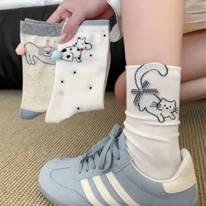 Cute cartoon cat and dog mid-tube socks with bow and pom-pom detail, comfortable fit.