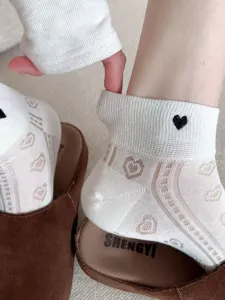 Detailed view of women's summer breathable thin low-cut socks with cute heart hollow-out design.