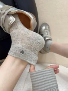 Comfortable grey low cut ankle socks for women with cute heart design and breathable mesh.