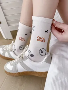 Detail view of white mid-calf socks with cute sheep pattern and letters for daily wear.