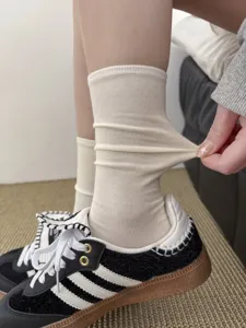 Detailed view of women's ribbed crew socks showing great elasticity and soft knit texture.