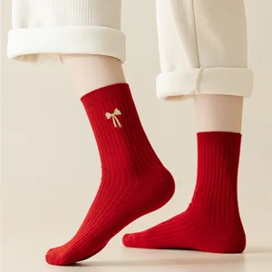 Red ribbed cotton socks for women, featuring a cute gold bow embroidery for festive wear.