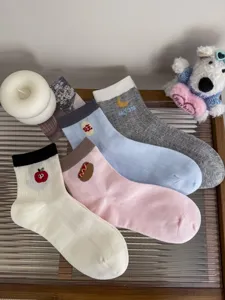 Cute cartoon embroidered cotton mid tube socks set featuring various fun patterns for daily wear.