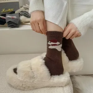 Close-up detail of cozy brown winter knit socks featuring cute puppy pattern worn with slippers.