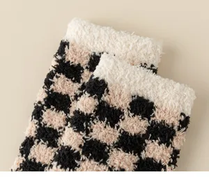 Close-up detail of fluffy plush checkerboard sleep socks, soft warm cozy homewear fabric.
