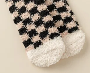 Cozy fluffy checkerboard sleep socks detail, soft warm coral fleece home floor socks.