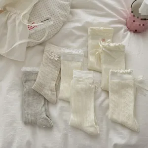 Japanese sweet style lace bow crew socks for women, fashionable cute white mid-calf hosiery.
