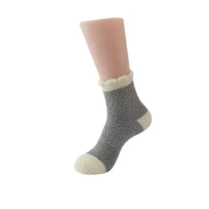 Nahaufnahme von gemütlichen dicken Plüsch-Hausschuhen in klassischem Grau und Beige.