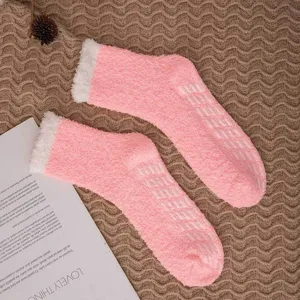 Pink fuzzy coral fleece socks with anti-slip grips for cozy winter indoor home floor wear.