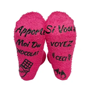 Pink fuzzy cozy winter socks with funny anti slip text soles for women comfort sleep.