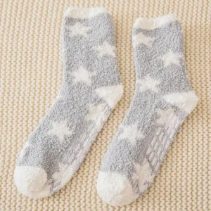 Detail view of cozy plush star pattern fuzzy socks with non-slip sole grips for indoor wear.