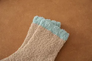 Close-up detail of cozy coral fleece winter mid-tube socks in khaki with mint green cuff.