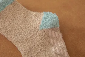 Cozy coral fleece fuzzy sleep socks with anti-slip grip sole for warm indoor winter wear.