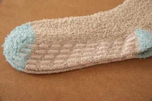 Detailed view of cozy coral fleece anti-slip floor socks with silicone grips for winter warmth.